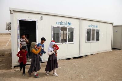 Iraqi Roma children leave their classroom. Haider Hamdani / AFP