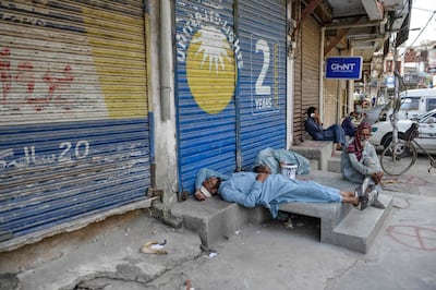Labourers sleep near a market closed for the weekend in Rawalpindi. AFP
