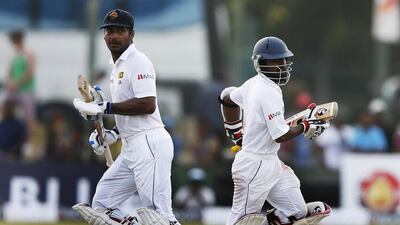Sri Lanka's Kumar Sangakkara, left, and Kaushal Silva run between the wickets during the fourth day of the first Test against South Africa in Galle on July 19, 2014. Dinuka Liyanawatte / Reuters