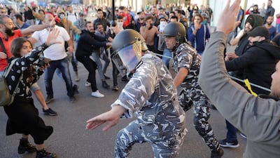 Anti-government protesters clash with riot police on a road leading to the parliament building in downtown Beirut. AP Photo