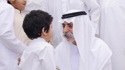 Sheikh Nahyan bin Mubarak, Minister of Culture, Youth and Community Development speaks to a boy while offering his condolences to the families of the fallen soldiers. Wam