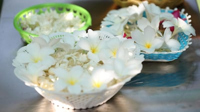 Offerings placed by the bodhi tree at Dubai's Buddhist temple. Chris Whiteoak / The National