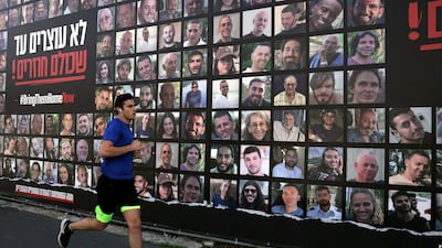 A billboard featuring portraits of Israelis hostages who have been held in Gaza since October 7, 2023. AFP