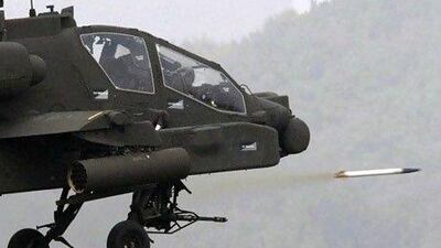 A US Apache helicopter fires a rocket during a military exercise. AP Photo