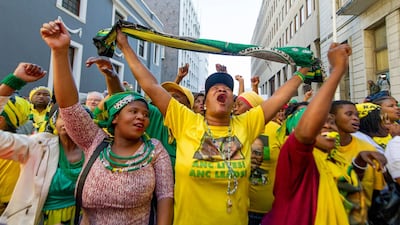 African National Congress (ANC) supporters are seen outside the South African parliament in Cape Town on August 8, 2017. AP