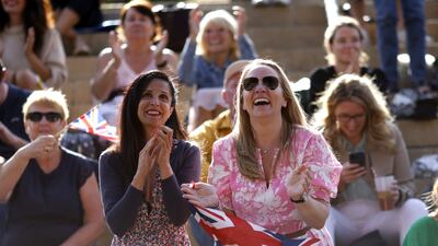 Fans celebrate after Emma Raducanu's victory. PA