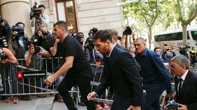 Lionel Messi, centre, arrives to court with his father Jorge Horacio Messi, right, to stand trial for tax fraud in Barcelona, Spain, June 2, 2016. Albert Gea / Reuters