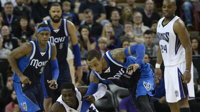 Monta Ellis of the Dallas Mavericks, right, goes for a loose ball against Darren Collison, centre, of the Sacramento Kings as his teammate Rajon Rondo, left, looks on during Dallas' win over Sacramento in the NBA on Tuesday. John G Mabanglo / EPA / January 13, 2015