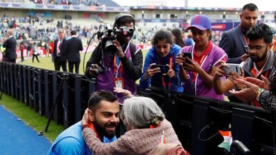 India's Virat Kohli meets India fan, Charulata Patel, at the end of the match. Action Images via Reuters