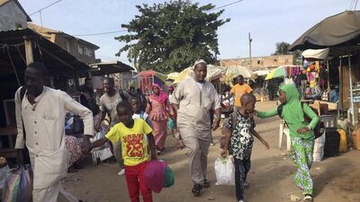 People walk to the ferry heading towards Senegal in Gambia’s capital Banjul as Gambia’s president Yahya Jammeh declared a state of emergency citing foreign interference in December’s presidential election. AP Photo