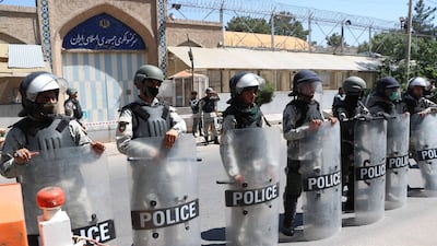 Afghan riot police stand guard outside the Iranian consulate during a protest against the Iranian regime and demand justice for the Afghans allegedly killed by the Iranian security forces, in Herat, Afghanistan, on May 11, 2020. EPA