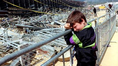 A child grieves at the site the day after a temporary stand collapsed at the Armand-Cesari stadium in Furiani near Bastia, France on May 5, 1992, causing 19 dead and over 2,000 injured. AFP