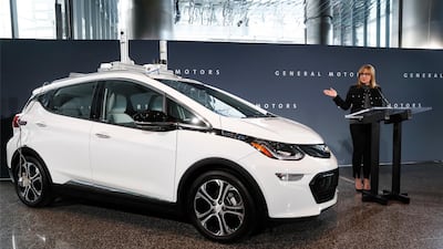 General Motors chief executive Mary Barra speaks next to an autonomous Chevrolet Bolt electric car in Detroit. AP