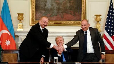 From left, Azerbaijan's President Ilham Aliyev, US President Donald Trump and Armenia's Prime Minister Nikol Pashinyan join hands at the White House in August 2025, after successful peace talks. EPA