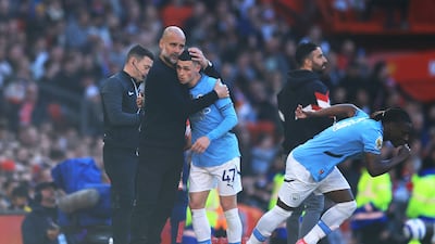 Manchester City manager Pep Guardiola, left, embraces Phil Foden after being substituted during the goalless draw against United. Getty Images