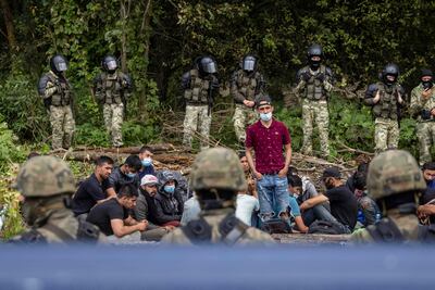 A group of people believed to be Afghan migrants in a village near the Poland-Belarus border. AFP