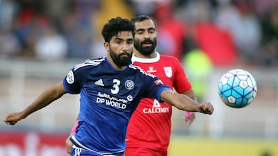 Salem Saleh Al Rejaibi of the Al Nasr club, left, vies for the ball against Mehdi Kiani of Iran's Tractor Sazi during their AFC Champions League round 16. Mehdi Zare / AFP