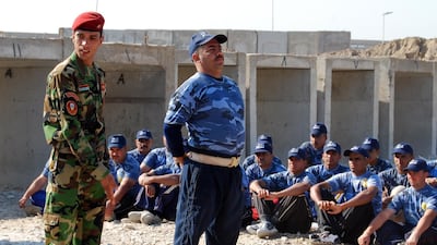 An Iraqi police instructor with a recruit in Baghdad. Authorities are under pressure to show they can control weapons on Iraqi soil. Photo: US Army