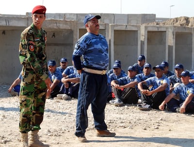 An Iraqi police instructor explains a drill to new recruits. Photo: US Army