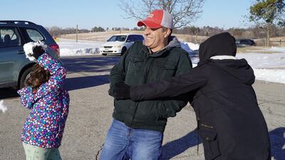 Hadi's daughters Yara, left, and Ayana throw snowballs at him