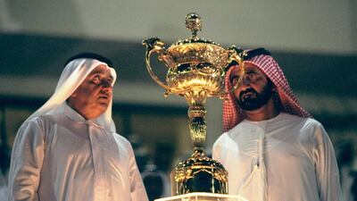Sheikh Mohammed bin Rashid looks at the Dubai World Cup trophy on March 28, 1999. Allsport