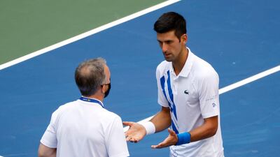 Novak Djokovic talks to the head of officiating at the International Tennis Federation Soeren Friemel. EPA
