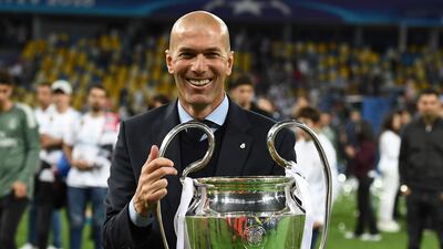 Zinedine Zidane celebrates with the trophy after overseeing Real Madrid's third successive Uefa Champions League title. Franck Fife / AFP