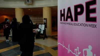 A student walks past a sign during the annual Health and Physical Education week at the Dubai Women’s College.