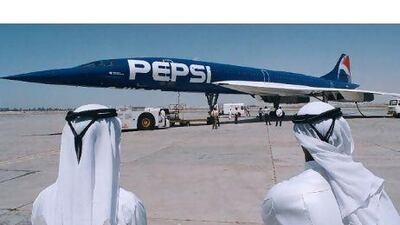Dubai aviation officials watch the arrival of Pepsi's Concorde, leased from Air France and sporting the new electric-blue Pepsi colours, which stopped over in the Gulf Arab emirate April 7 while on a whirlwind marketing tour of the Middle East. The visit is part of a $500 million project called " Project Blue" to win back market shares from arch-rival Coca-Cola. While in Dubai, Pepsi took 100 VIP guests on a supersonic flight. The flight arrived from Beirut and will continue on to Jeddah and Cairo.