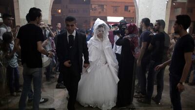 The bride and groom walk into the wedding hall.