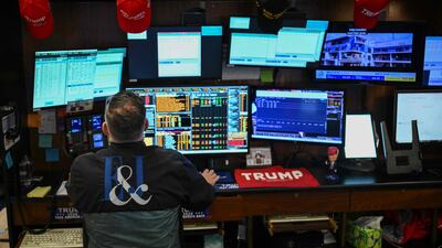 Merchandise for US President Donald Trump and his Maga movement is seen on the floor of the New York Stock Exchange. Markets have see-sawed as Mr Trump flip-flops over his tariff regime. AFP