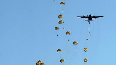 A photo taken from the ground in southern Seoul shows parachuters practicing for a show on Armed Forces Day. Yonhap / EPA