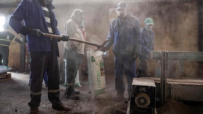Workers fill bags with fertiliser in the Elephant Vert factory in the 'Agropolis' industrial zone in Morocco's northern city of Meknes. AFP