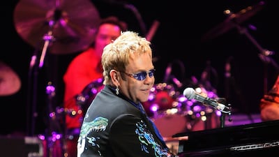 Elton John, wearing a suit with a crocodile and water print, performs his 'The Captain And The Kid Tour' in Sydney, Australia on November 28, 2006. Getty Images