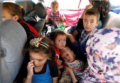 Afghan children ride in a vehicle as they flee their houses following heavy fighting in Ghazni Province. Reuters