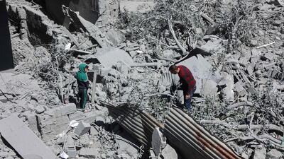 Palestinians inspect the rubble of a home after it was destroyed in an Israeli strike in Gaza city on Wednesday. AFP
