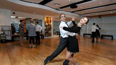 Safwat Gerges, the general manager of Dubai's Arthur Murray dance studio, dances with Yana Gorbunova at the Jumeirah Lake Towers studio.