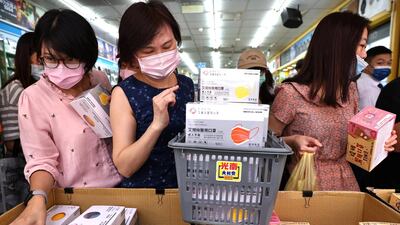 People buy boxes of face masks in Taipei, Taiwan. Reuters