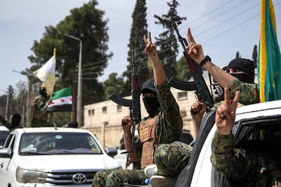 SDF fighters leave the city of Aleppo as part of an agreement with the Syrian government. EPA