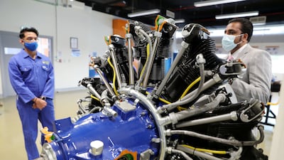 Sarath Raj, Programme Leader, Aerospace Engineering, right, explaining to the Aerospace Science students about the radial engine at Amity University's Aerospace Lab in Academic City in Dubai. Pawan Singh / The National