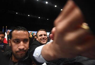 Then presidential candidate Emmanuel Macron stands next to bodyguard Alexandre Benalla as he shakes hands with supporters as he arrives for a campaign rally near Marseille in November 2017. AFP