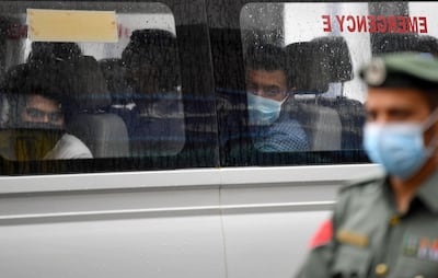 Foreign workers who have tested positive to the novel coronavirus at a testing centre in Dubai are transported to a specialised centre for isolation and treatment. AFP