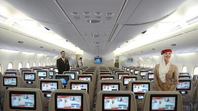 Cabin crew show the economy class cabin of an Emirates Airbus A380 at the India Aviation 2014 airshow. In January, Indian aviation authorities agreed to allow Emirates and flydubai 11,000 extra seats a year. Noah Seelam / AFP