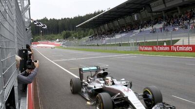 Mercedes Formula One driver Lewis Hamilton of Britain crosses the finish line to win the Formula One Austrian Grand Prix. Ronald Zak / Pool / Reuters