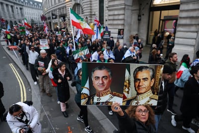 Iranians marching against the regime in London on Sunday hold pictures of Reza Pahlavi, grandson of the deposed Shah. Reuters