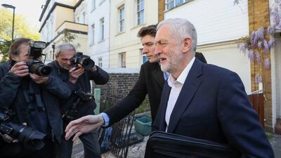 Jeremy Corbyn, leader of Britain's opposition Labour Party, right, passes a group of photographers as he leaves home in London on Wednesday, April 19, 2017. Chris Ratcliffe / Bloomberg