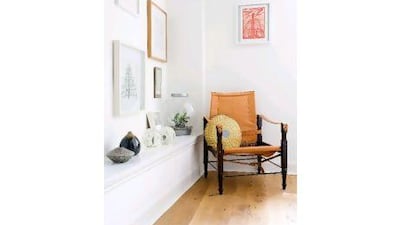 Top, a chair from a market in Marrakech and framed artworks line the hallway.Douglas Gib / Gap Interiors