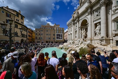 Tiny tourism doesn't mean avoiding attractions, such as the Trevi Fountain in Rome, but considering peak times and traffic. AFP