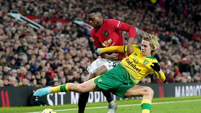 Manchester United's Aaron Wan-Bissaka vies for the ball with Norwich City's Todd Cantwell. Reuters