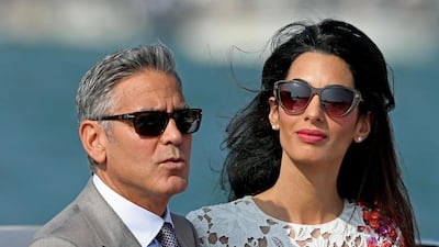 George and Amal Clooney, in a floral Giambattista Valli dress, in Venice on September 28, 2014. EPA